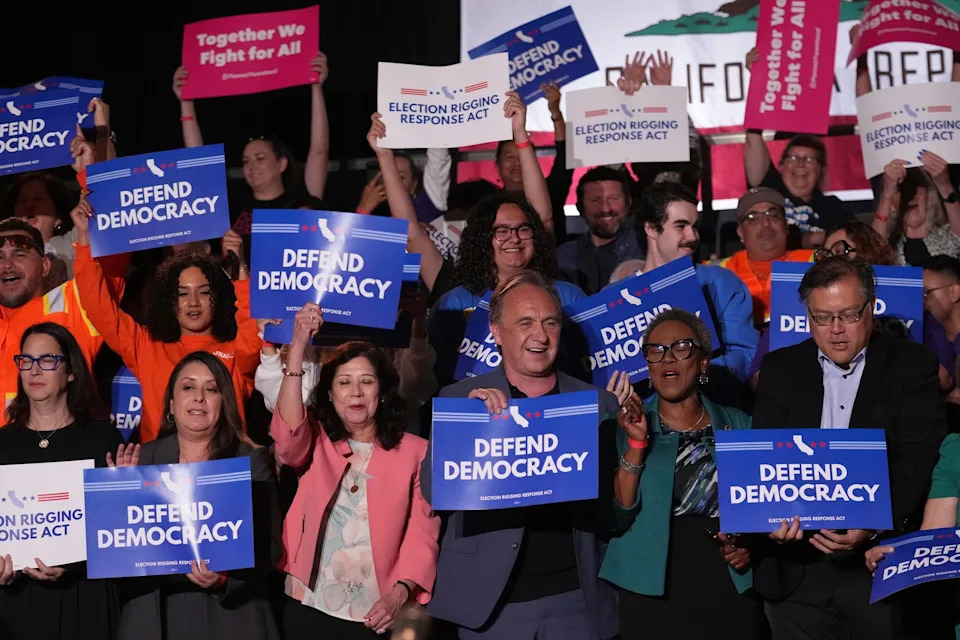 Marcio Jose Sanchez/AP - PHOTO: People await a news conference with California Gov. Gavin Newsom, Aug. 14, 2025, in Los Angeles.