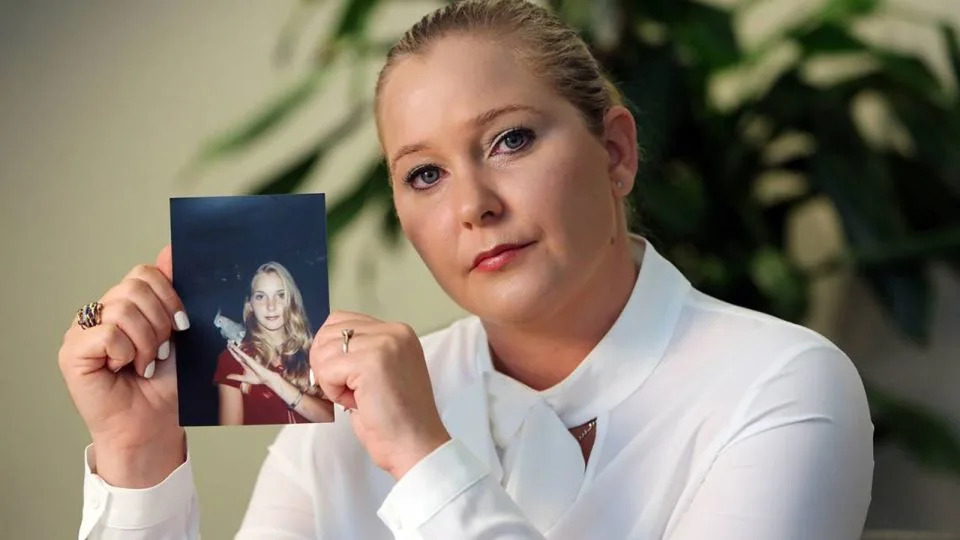 Virginia Giuffre holds a photo of her younger self. - Miami Herald/TNS/Getty Images
