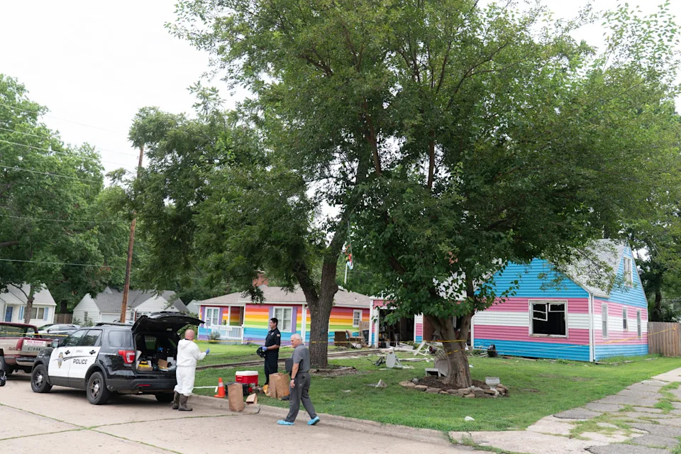 Topeka police talk July 30 outside Topeka's "Mott House" at 1204 SW Orleans, where they were investigating the death earlier that day of a man suspected of committing a homicide in Oklahoma City, Oklahoma.