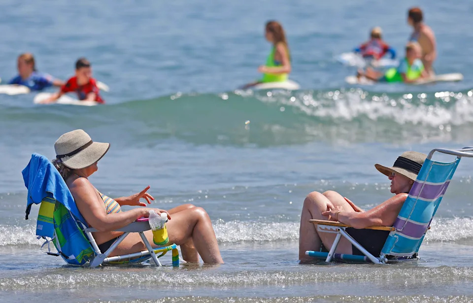 Hortencia Kenney, of Dorchester, and her mother-in-law, Mary Kenny, of Braintree, cool off at Nantasket Beach in Hull on Wednesday, July 30, 2025.
