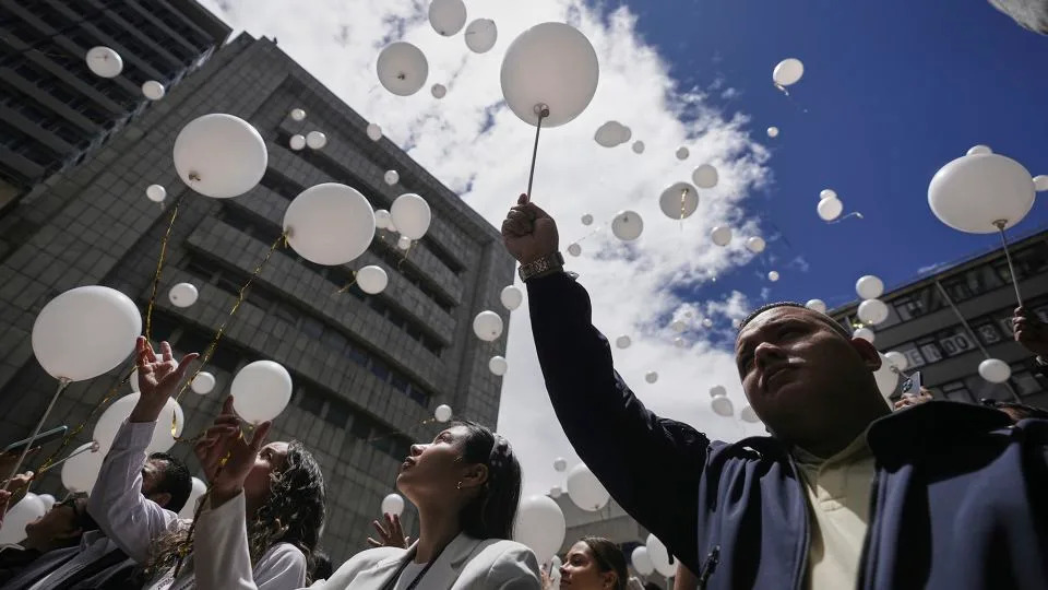 Employees of the attorney general's office release balloons during a ceremony to honor opposition Sen. Miguel Uribe, after his death more than two months after he was shot during a political rally, in Bogota, Colombia, Monday, Aug. 11, 2025. - Ivan Valencia/AP