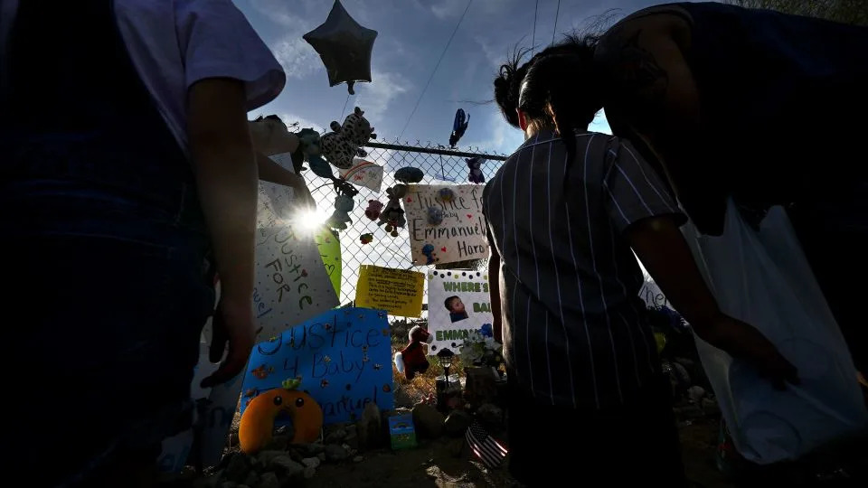 People gather around a makeshift memorial for Emmanuel Haro outside the boy's home in Cabazon, California, on Friday. - Will Lester/MediaNews Group/Inland Valley Daily Bulletin/Getty Images