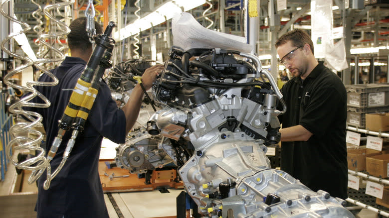 TOLEDO, OH - AUGUST 28: Assembly line workers do final inspection on an engine for the new 2007 Jeep Wrangler August 28, 2006 at the new DaimlerChrysler Toledo Supplier Park (TSP) in Toledo, Ohio. TSP is the first North American auto plant to have three major vehicle-building operations run and managed by suppliers.