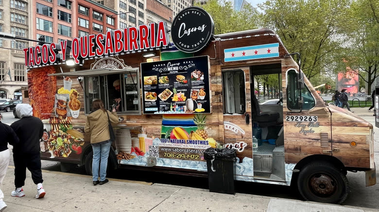 A Customer Orders Food From a Brown Food Truck on East Monroe Street in May 2025 in Chicago.