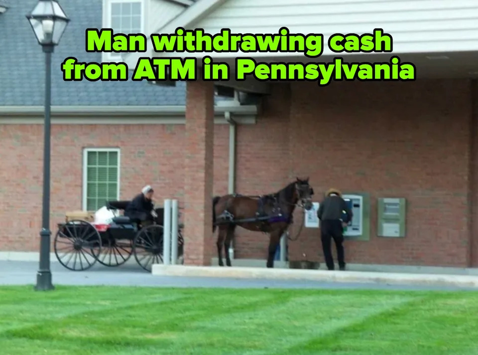 Horse-drawn carriage at a drive-thru ATM with two people; one uses the ATM while the other waits in the carriage