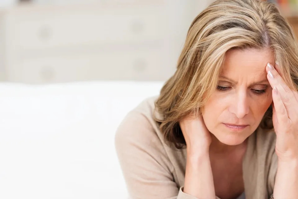 Woman alone looking upset.