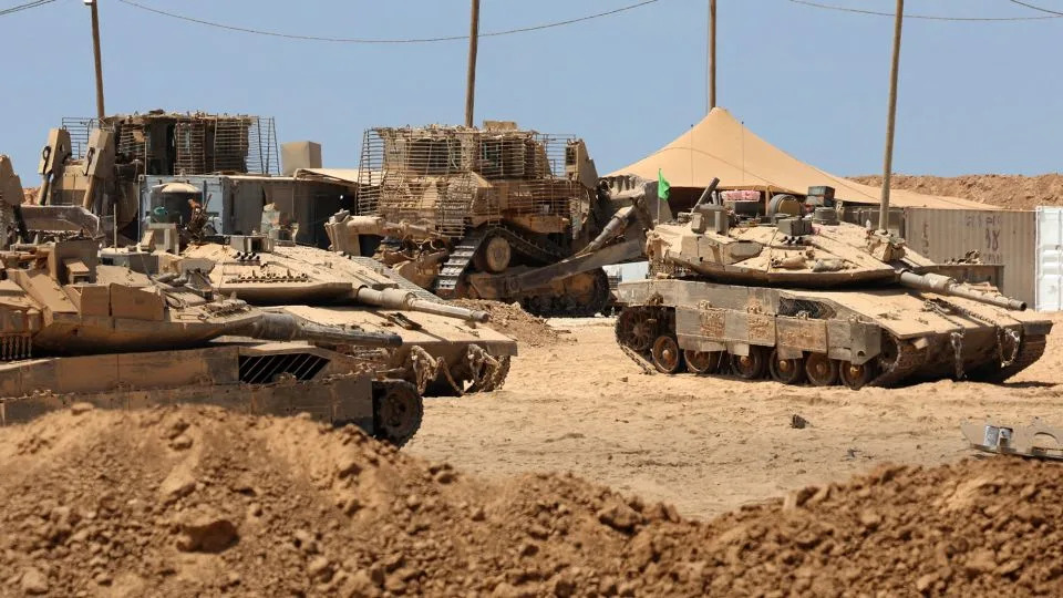 Israeli military vehicles are positioned along the border with the Gaza Strip on Thursday. - Jack Guez/AFP/Getty Images