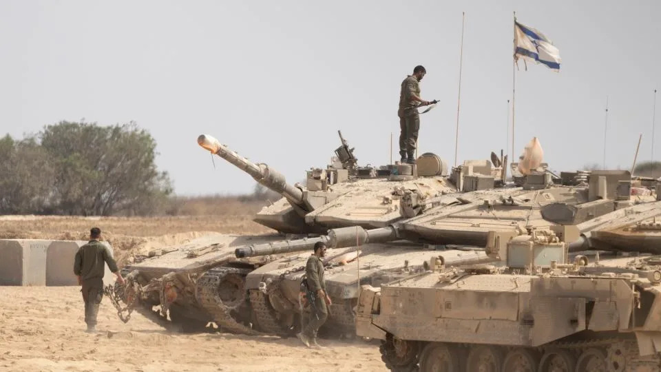 Israeli soldiers work near tanks in a gathering point near the border with the Gaza Strip, in Southern Israel, Israel on Wednesday. - Amir Levy/Getty Images