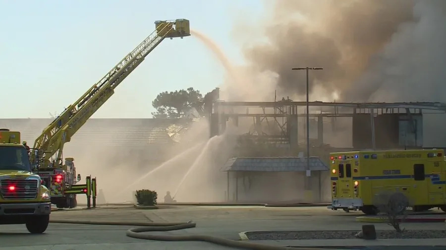 Clark County fire crews battle a large blaze at a business complex across the street from the UNLV campus on Maryland Parkway, near Tropicana Avenue on July 25, 2025. (KLAS)